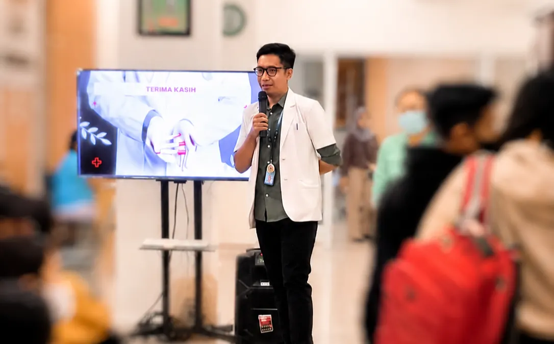 Gus Bhas giving a health talk with a microphone